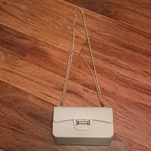 Rose gold cross-body bag with rose gold accents